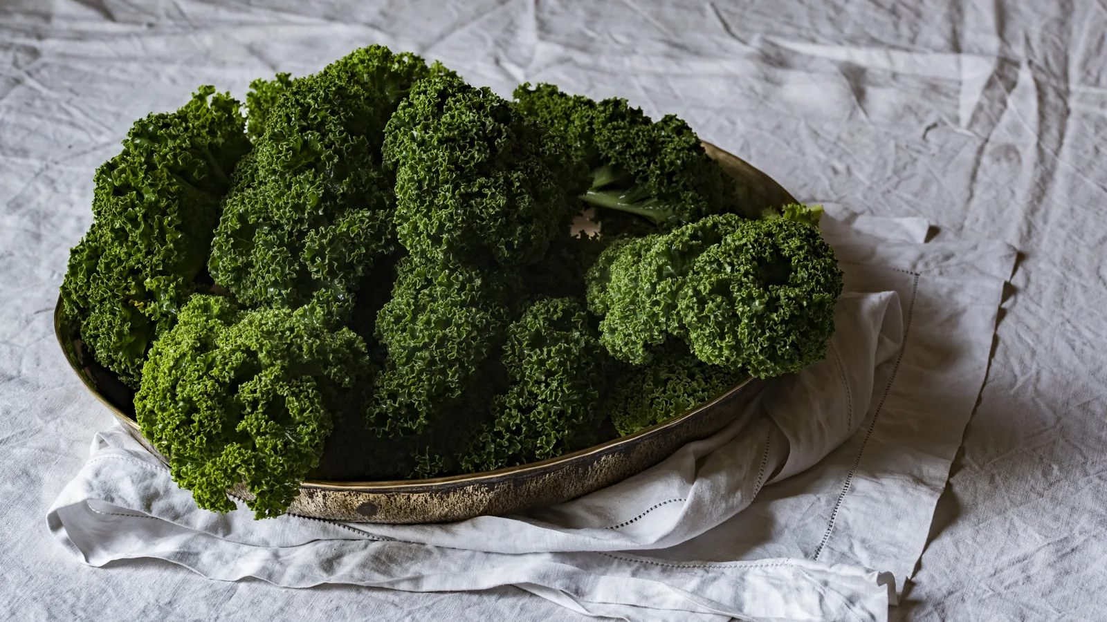 A colorful flat-lay of fresh vegetables and ingredients on a bright surface